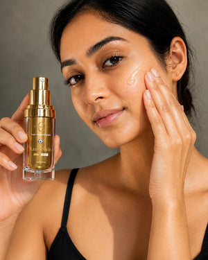 Woman applying skincare product to her face with a bottle of Laneige Skin in the foreground.