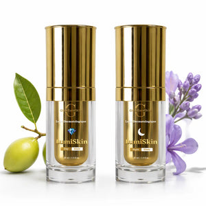 Two gold and clear skincare bottles with green leaf and purple flowers on a white background